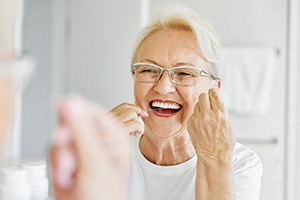 A woman flossing her teeth
